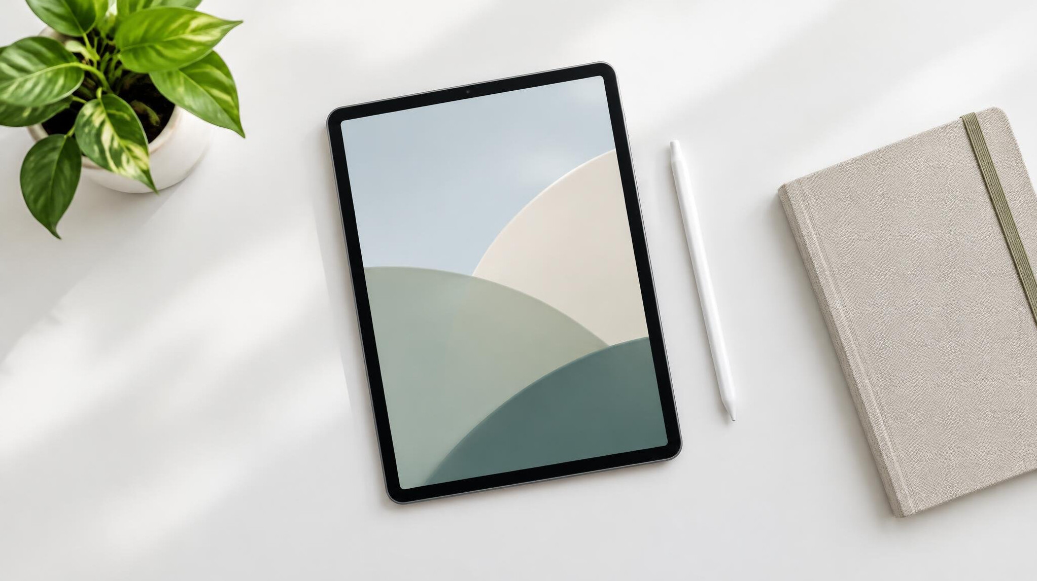 Tablet with stylus lying on a clean white desk